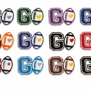 May include: A collection of twelve embroidered patches featuring the word "GO" in various colors, paired with a football. Each football has a heart or star. The patches are suitable for apparel.