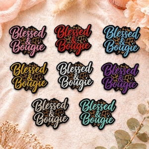 May include: A collection of embroidered patches with the words "Blessed & Bougie" in various colors. The patches feature a leopard print background and are in pink, red, blue, yellow, black, purple, silver, and teal.