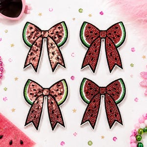 May include: Four decorative bow-shaped patches featuring a watermelon design. Two bows are covered in pink sequins, and two are covered in deep red sequins. Each bow has a green border and black seed-like accents, with a white outline.