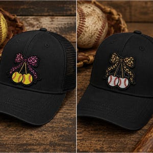 May include: Black baseball cap with a mesh back and a decorative patch. The patch features a bow and two baseballs. One cap has a pink bow with yellow baseballs, the other has a leopard print bow with white baseballs.