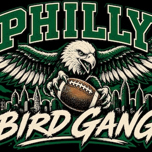 May include: A graphic illustration featuring a bald eagle with spread wings clutching a brown football. Above the eagle is the text PHILLY in green, and below is the text BIRD GANG in white. A dark city skyline silhouette is visible in the background.
