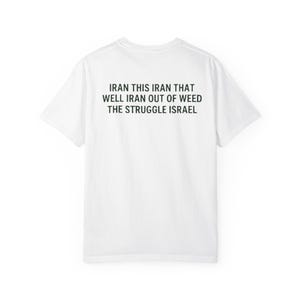 Op de afbeelding: Wit t-shirt met zwarte tekst op de achterkant. De tekst luidt: "IRAN THIS IRAN THAT WELL IRAN OUT OF WEED THE STRUGGLE ISRAEL". Het shirt heeft een ronde hals.