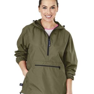 May include: A green hooded jacket with a zip and a large pocket on the front. The jacket has a drawstring hood and a relaxed fit.