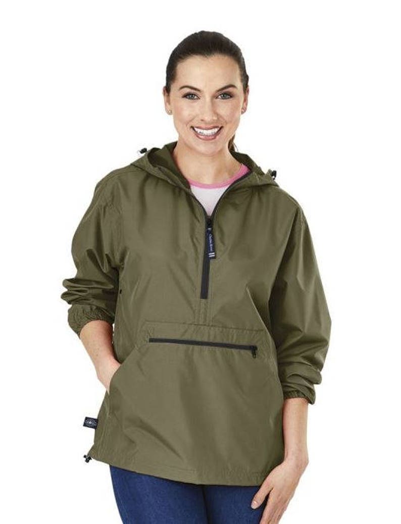 May include: A green hooded jacket with a zip and a large pocket on the front. The jacket has a drawstring hood and a relaxed fit.