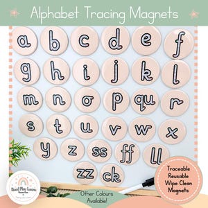 May include: A set of round, light pink alphabet tracing magnets featuring lowercase letters with dotted lines for guidance. The magnets include individual letters from a to z, plus digraphs like ss, ff, ll, zz, and ck, all designed for educational use.