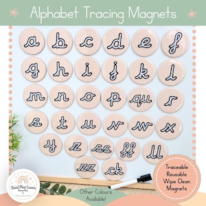 May include: A set of round, light-coloured alphabet tracing magnets featuring lowercase cursive letters, digraphs, and double letters. Each magnet displays a dotted path for tracing. A black dry-erase marker is included for use.