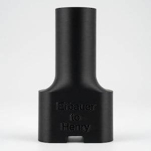 May include: A black, cylindrical object with a flared base and a narrower, elongated top. The text "Erbauer to Henry" is printed on the base. The object has a matte finish and appears to be 3D-printed.