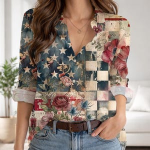 May include: A long-sleeved button-down shirt with a patriotic design. The shirt features a collage of American flag elements, floral patterns, and a checkered design. The color palette includes shades of blue, red, white, and beige. The shirt is paired with blue jeans and a brown belt.