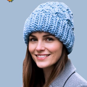 May include: A light blue, super chunky knit hat. The hat is worn by a person. The text "Ribs on Ribs Hat Knitting Pattern" and "Adult" are visible. A colorful sheep logo is in the upper left corner.