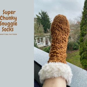 May include: A pair of brown chunky knit socks with a white faux fur cuff. The socks are knitted in a cable stitch pattern. The socks are being worn by a person's foot. The image is titled "Super Chunky Snuggle Socks Knitting Pattern".