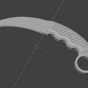May include: A grey karambit knife with a curved blade and a finger ring. The handle has a textured pattern. The knife is set against a dark grey grid background.