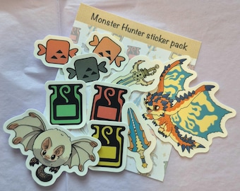 May include: A collection of colorful Monster Hunter sticker pack. The stickers feature various game-related designs, including a bat, a dragon, weapons, and other icons. The text "Monster Hunter sticker pack" is visible on a brown card.