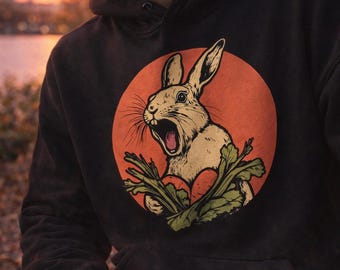 Sudadera con capucha y estampado de conejito: acogedora mezcla de algodón y poliéster, corte unisex.