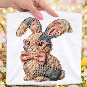 May include: A white square fabric featuring a patchwork bunny design. The bunny has heart-shaped glasses, a bow tie, and is made of floral and denim fabrics. The bunny is a whimsical Easter or spring-themed design.