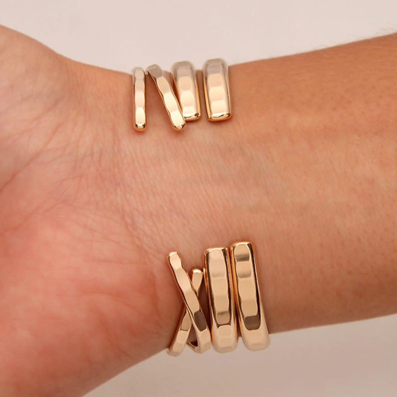 May include: Gold-toned bracelet with a hammered finish, featuring multiple bands that wrap around the wrist.