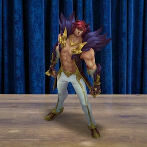 May include: A collectible figurine of a muscular character with red hair and animal-like ears. The figure wears a dark purple fur-lined collar, gold shoulder armor, a gold necklace, white pants with gold trim, and matching gold and dark red footwear.