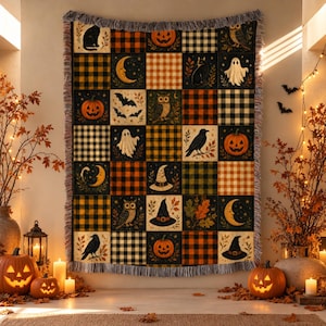 May include: A rectangular woven throw blanket featuring a patchwork grid design with alternating squares of black, orange, and cream buffalo plaid patterns and illustrations of pumpkins, ghosts, owls, cats, bats, moons, and witch hats.