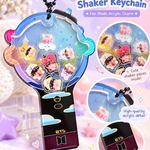 May include: A light stick shaker keychain featuring a blue and black acrylic charm with the text Light Stick Shaker Keychain and Fan Made Acrylic Charm. The charm contains small character pieces inside and displays the BTS logo and text.