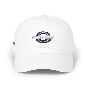 May include: White baseball cap with the text "ECHO THEORY" in a black and silver design on the front. The cap also features the year "2026" on the side. The cap has a curved brim and a button on top.