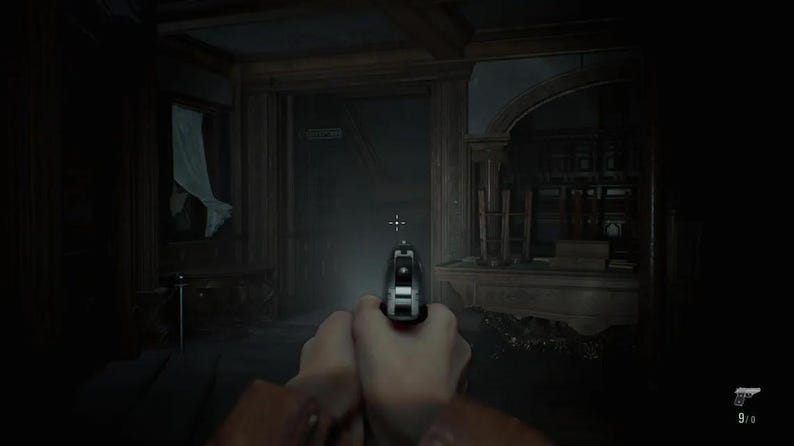 May include: A first-person perspective of a silver handgun held in two hands, aimed forward in a dimly lit, shadowed room with wooden architectural details. A small white crosshair is visible in the center, and a gun icon with 9/0 text is in the corner.