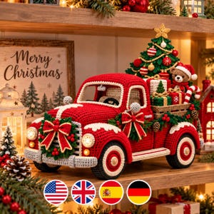 May include: A red crocheted pickup truck carrying a decorated Christmas tree, wrapped gifts, and a small teddy bear wearing a Santa hat. The truck features a front wreath with a red bow, white accents, and a sign reading Merry Christmas.