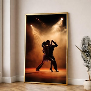 May include: A framed print depicts a couple dancing the tango under stage lights. The dancers are silhouetted against a smoky, orange-toned background. The woman wears a short dress, and the man is in a suit. The gold frame adds a touch of elegance.