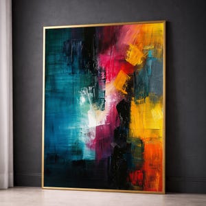May include: A large rectangular abstract painting framed in gold, featuring bold, expressive brushstrokes in deep teal, vibrant magenta, bright yellow, and orange, with dark black accents creating a high-contrast, textured composition.