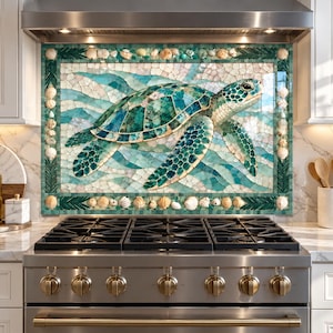 May include: A rectangular kitchen backsplash mural featuring a mosaic sea turtle in shades of teal, green, and white. The central turtle is surrounded by a border of small white seashells and dark green tiles, set above a stainless steel stove.