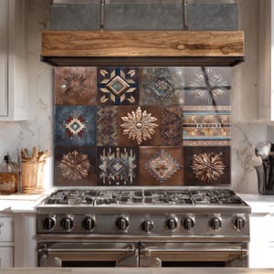 May include: Decorative kitchen backsplash featuring a grid of square tiles with embossed designs. The tiles showcase a variety of patterns in shades of brown, blue, and copper. The backsplash is installed above a stainless steel gas range.