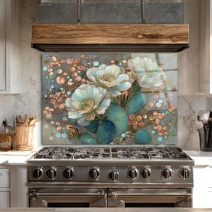 May include: A decorative kitchen backsplash featuring a floral design with white and light blue flowers, teal cactus, and small pink flowers. The artwork is set against a muted blue and brown background.