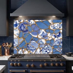 May include: A kitchen backsplash panel featuring a mosaic pattern of blue and white porcelain shards joined by gold-colored lines. The design incorporates various floral and geometric patterns typical of traditional ceramic plates and pottery.