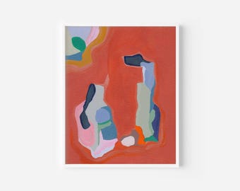 May include: Abstract art print in a white frame. The artwork features organic shapes in shades of red, pink, blue, green, and orange against a red background. The shapes appear to be layered, creating depth and visual interest.