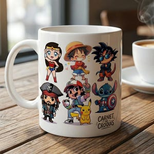 May include: White ceramic mug with cartoon characters such as Wonder Woman, Luffy, Goku, and Stitch. The mug is on a wooden table next to a cup of coffee. The mug has a large handle and the text "Carnet de Croquis".