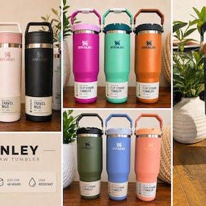 K&ouml;nnte beinhalten: Eine Sammlung von Stanley Reisebechern und Trinkbechern mit Klappstrohhalm in verschiedenen Farben wie Gelb, Pink, Schwarz, Magenta, T&uuml;rkis, Orange, Olivgr&uuml;n, Blau und Pfirsich. Jeder Beh&auml;lter verf&uuml;gt &uuml;ber einen Griff, einen Deckel und ein Etikett.