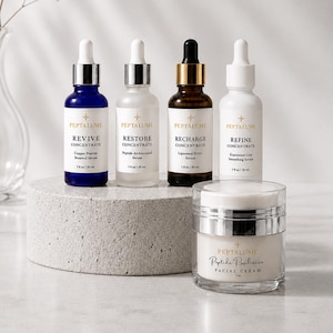 May include: Four glass dropper bottles labeled Peptalume Revive, Restore, Recharge, and Refine, each containing 1 fl oz/30 ml of serum, arranged behind a clear jar of Peptalume Peptide Resilience Facial Cream, which contains 1 oz of product.