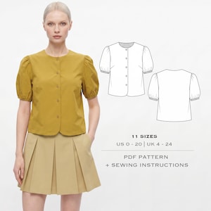 May include: A mustard yellow short-sleeved blouse with a round neckline and button-down front, paired with a beige pleated skirt. Includes a technical line drawing of the blouse, text stating 11 SIZES US 0-20 | UK 4-24, PDF PATTERN + SEWING INSTRUCTIONS.