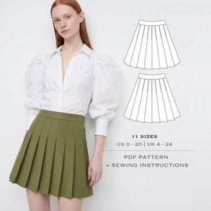 May include: A white long-sleeved shirt with puff sleeves and a pleated olive green skirt. The image includes a technical line drawing of the skirt, the text 11 SIZES US 0 - 20 | UK 4 - 24, and the text PDF PATTERN + SEWING INSTRUCTIONS.