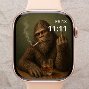 May include: A smartwatch with a custom face featuring a brown, hairy Sasquatch smoking a cigarette and giving the middle finger. The time is 11:11, and the date is FRI13. The watch has a rose gold case and a light pink band.