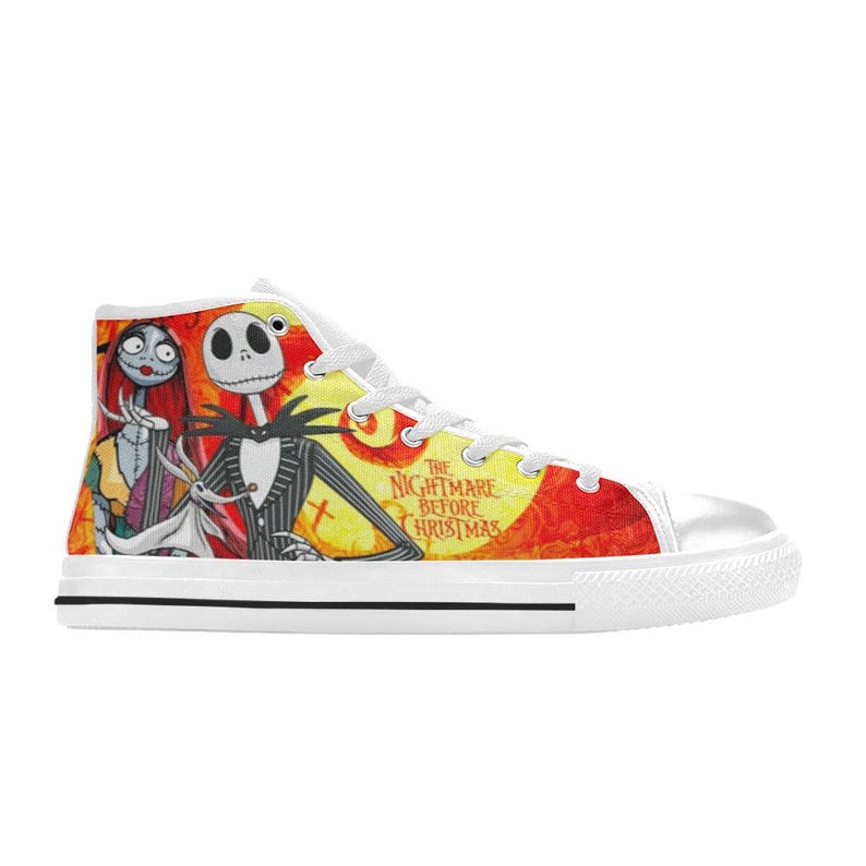 May include: A white high-top sneaker featuring a vibrant graphic print of Jack Skellington, Sally, and Zero from The Nightmare Before Christmas. The design includes a bright yellow moon, orange background, and white laces with a white rubber sole.