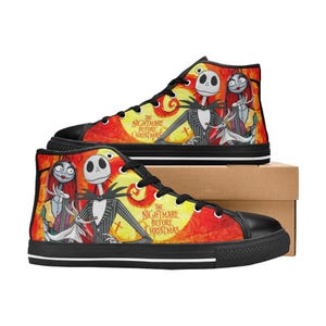 May include: High-top sneakers featuring a vibrant orange and yellow background with a graphic print of Jack Skellington, Sally, and Zero. The text "The Nightmare Before Christmas" is printed on the side. The shoes have black laces and soles.