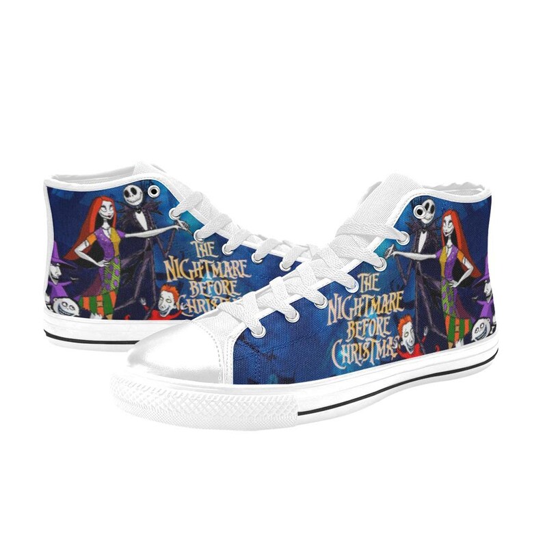 May include: High-top sneakers featuring a blue background with a graphic print of characters from The Nightmare Before Christmas, including Jack Skellington and Sally. The shoes have white laces, white rubber toe caps, and white soles.