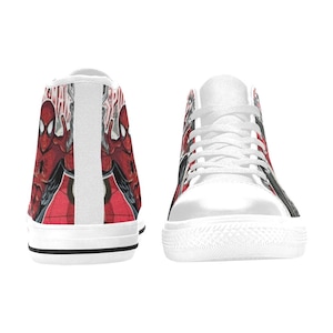 May include: A pair of high-top canvas sneakers featuring a red and black Spider-Man comic book graphic print. The shoes have white laces, white rubber toe caps, and white rubber soles with a thin black stripe running along the side of the base.