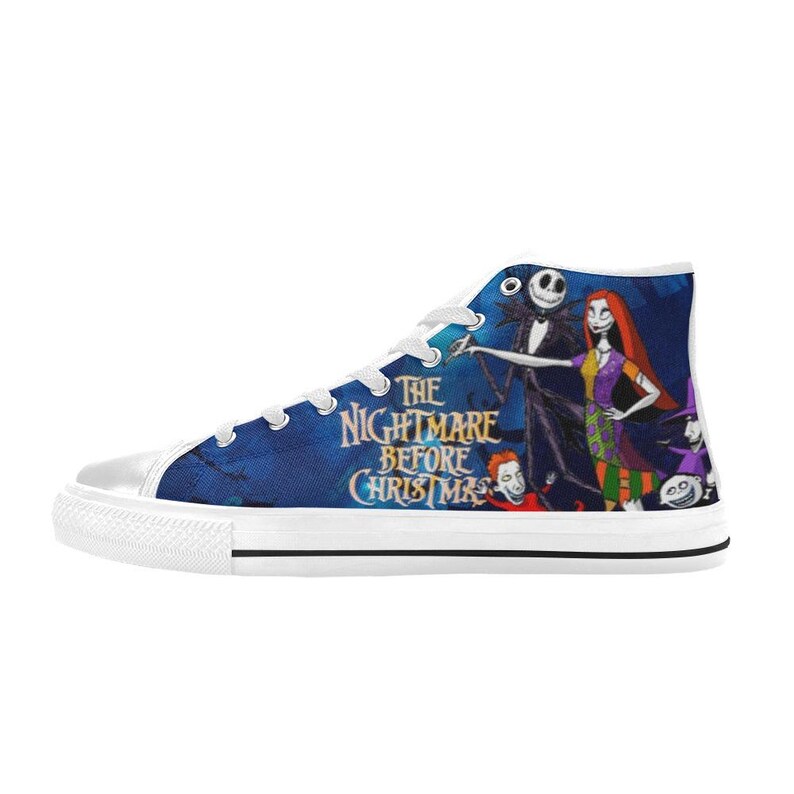 May include: A high-top sneaker with a blue canvas upper featuring a graphic print of Jack Skellington and Sally from The Nightmare Before Christmas. The shoe includes white laces, a white rubber toe cap, and a white rubber sole with black trim.
