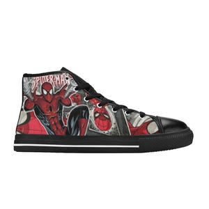 May include: A high-top sneaker featuring a comic book graphic print of Spider-Man in red and blue. The shoe has black laces, a black rubber toe cap, a black sole with a thin white stripe, and the text Spider-Man printed in a bold red font.