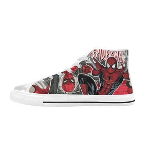 May include: A high-top sneaker featuring a comic book graphic print of Spider-Man in red and black colors. The shoe has white laces, a white rubber toe cap, and a white rubber sole with a thin black stripe. The text Spider-Man is printed in red.