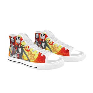 May include: High-top sneakers featuring a vibrant yellow and orange background with a graphic print of Jack Skellington, Sally, and Zero from The Nightmare Before Christmas. The shoes have white laces, white rubber toe caps, and white rubber soles.