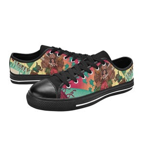 May include: Pair of black canvas sneakers featuring a colorful graphic design. The design includes characters and imagery from a popular animated film. The shoes have black laces, a black toe cap, and a white stripe along the sole.