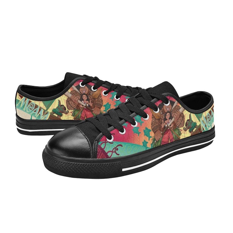 May include: Pair of black canvas sneakers featuring a colorful graphic design. The design includes characters and imagery from a popular animated film. The shoes have black laces, a black toe cap, and a white stripe along the sole.