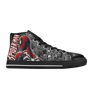 May include: High-top canvas sneaker featuring a Spider-Man design. The shoe has a black toe cap, laces, and sole. The side displays Spider-Man in red and black, with the words "SPIDER-MAN" in white.