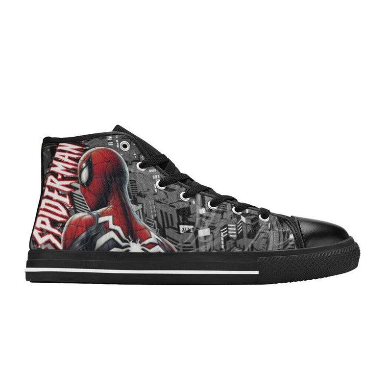 May include: High-top canvas sneaker featuring a Spider-Man design. The shoe has a black toe cap, laces, and sole. The side displays Spider-Man in red and black, with the words "SPIDER-MAN" in white.
